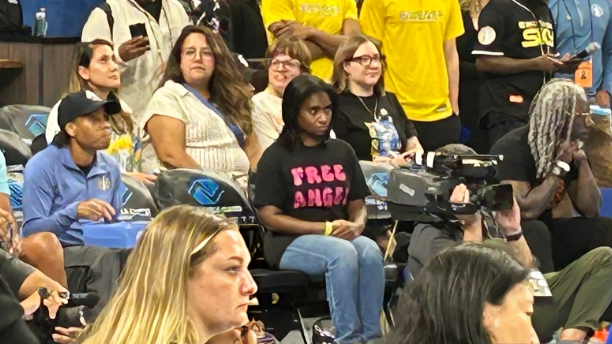 Cameras Caught Angel Reese's Fan With 'Free Angel' Shirt Moments Before Security Escorts Her To Courtside Seats