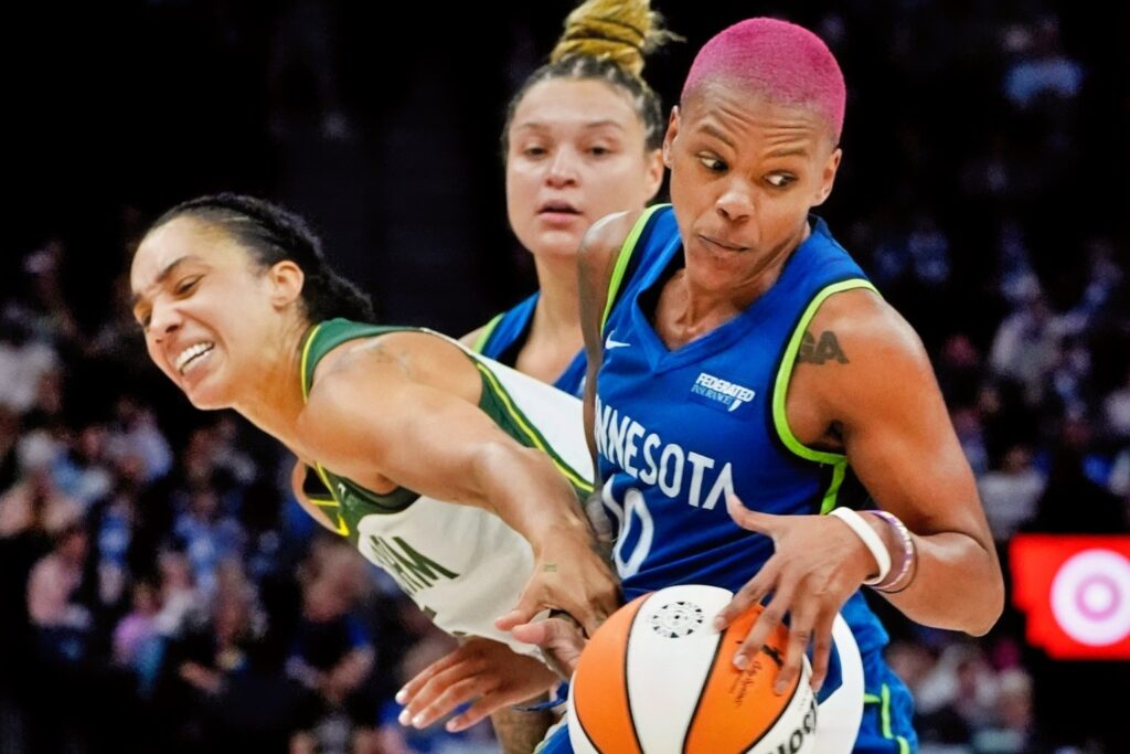 Minnesota Lynx Guard Courtney Williams Tries to Take the Ball Away from Seattle Storm Forward Gabby Williams